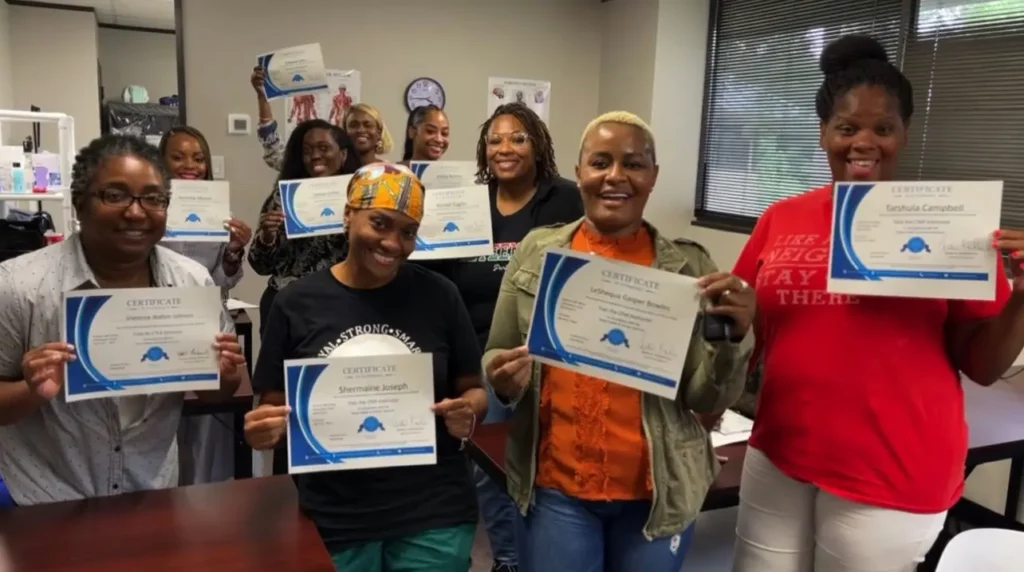 A group of women with certificates