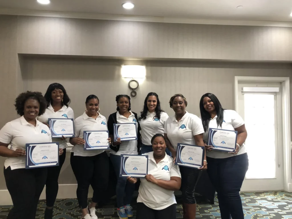 Trainers holds certificate for a photo